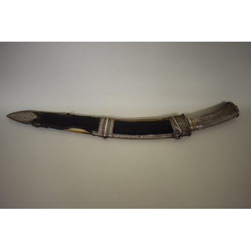 1748 - A Nepalese Sirupate khukuri, having ornate white metal handle and white metal mounts to scabbar... 