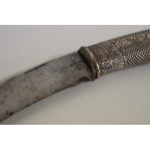 1748 - A Nepalese Sirupate khukuri, having ornate white metal handle and white metal mounts to scabbar... 