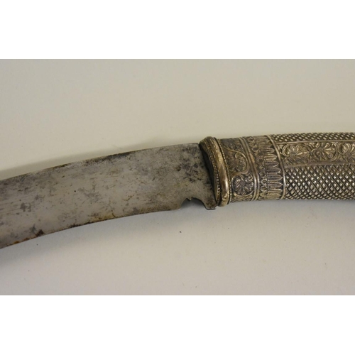 1748 - A Nepalese Sirupate khukuri, having ornate white metal handle and white metal mounts to scabbar... 