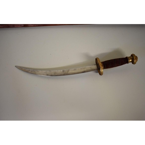 1752 - A theatrical dagger and sheath, by White's; together with another triangular blade sword and scabbar... 