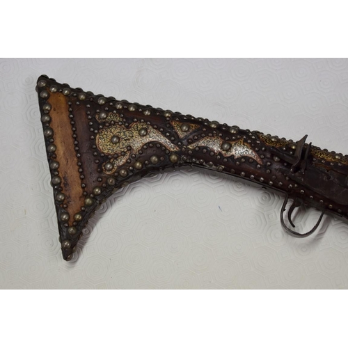 1785 - A decorative Arab flintlock musket, with studded metal and bone stock.