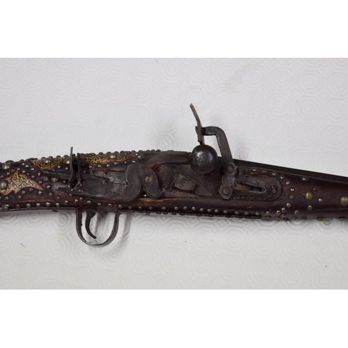 1785 - A decorative Arab flintlock musket, with studded metal and bone stock.