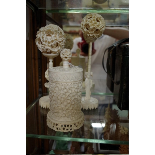 1797 - Two Chinese ivory concentric puzzle balls on stands; together with another Chinese carved ivory vase... 