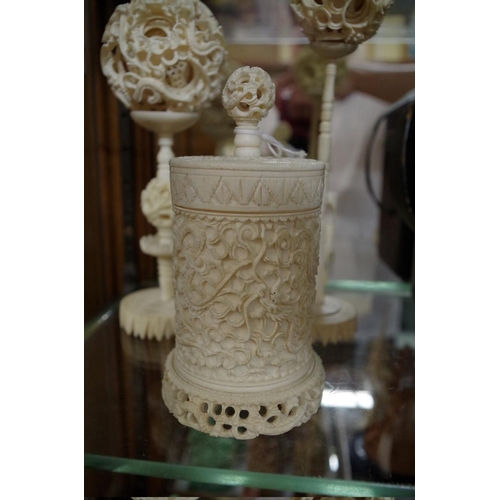 1797 - Two Chinese ivory concentric puzzle balls on stands; together with another Chinese carved ivory vase... 