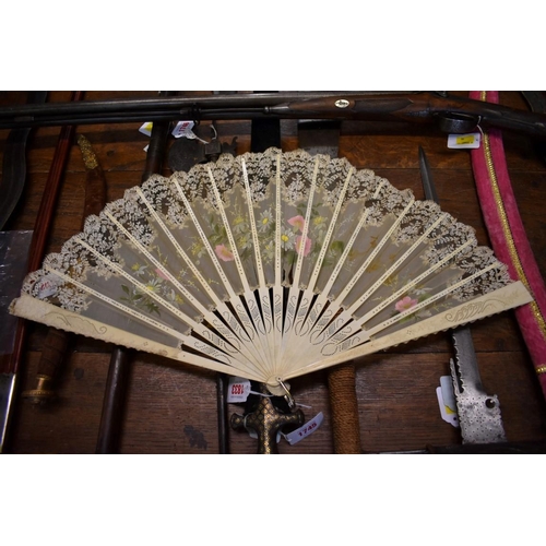 1833 - A bone and lace fan, the guards 35cm long, in card box. 