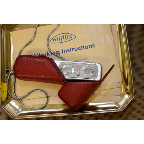 1845 - A Minox miniature camera in red leather case, circa 1951, No. 33989, with instruction booklet.... 