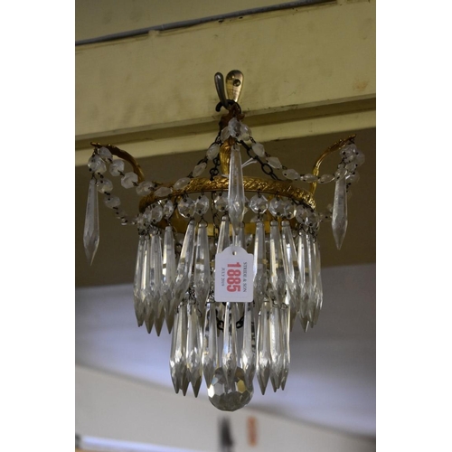 1885 - A brass and faceted glass drop two tier chandelier. 