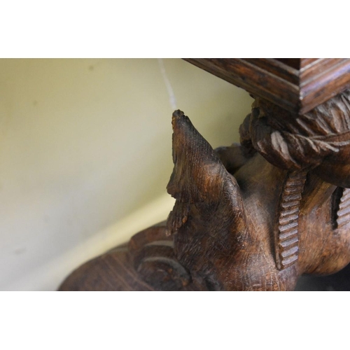 1952 - An antique carved oak and grey marble console table, with figural supports, 101cm wide.... 