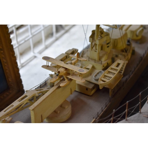 1953 - A painted model of a battleship, on chipboard base, total width 132cm.