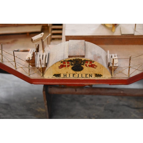 1954 - A painted wood model of a paddle steamer, 83cm long, on wood stand. 