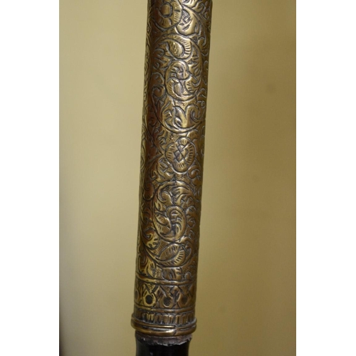 1961 - An Indian ceremonial spear, having ebony and brass mounted shaft and associated decorative sheath, 2... 