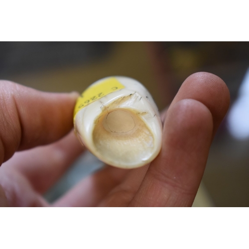 1842 - A small scrimshaw tooth, engraved with a galleon, signed 'Jones', 8.7cm long.