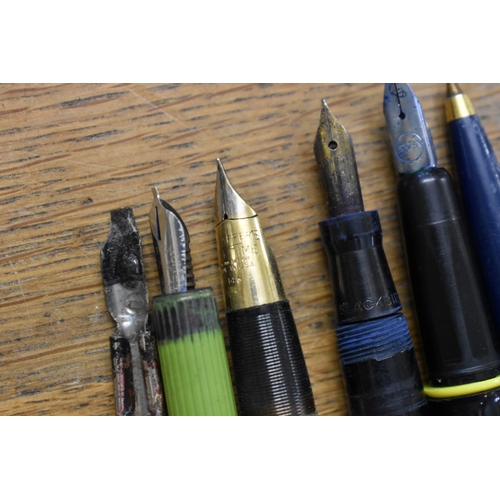 1857 - A quantity of fountain pens and pencils, to include: examples with 14ct nibs.