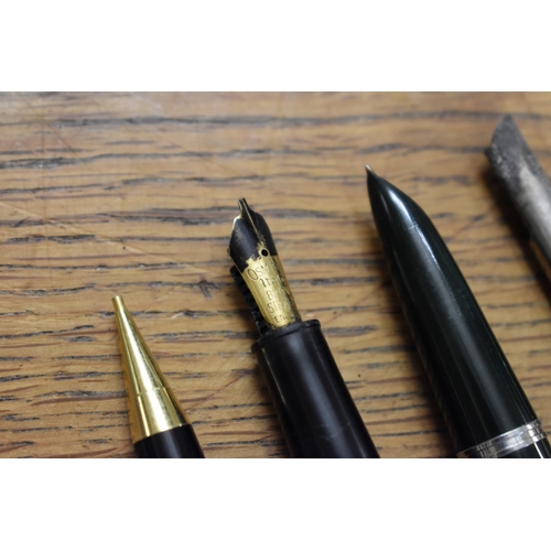 1857 - A quantity of fountain pens and pencils, to include: examples with 14ct nibs.