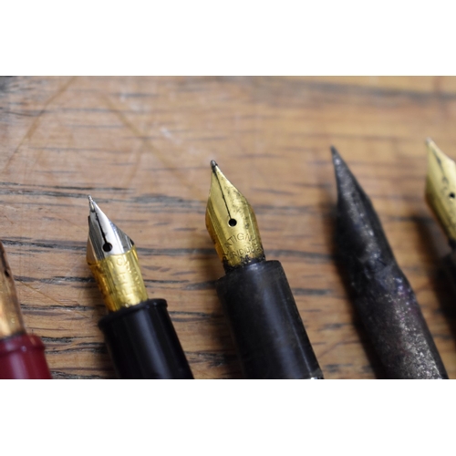 1857 - A quantity of fountain pens and pencils, to include: examples with 14ct nibs.