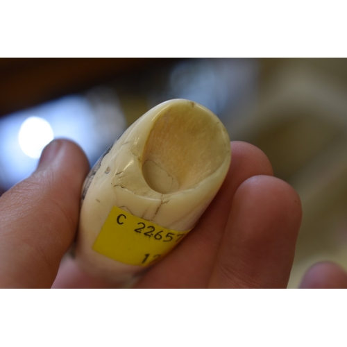 1842 - A small scrimshaw tooth, engraved with a galleon, signed 'Jones', 8.7cm long.