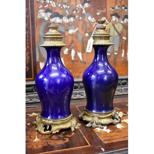 1343 - A pair of antique blue glazed porcelain and brass mounted rococo table lamps, the porcelain probably... 