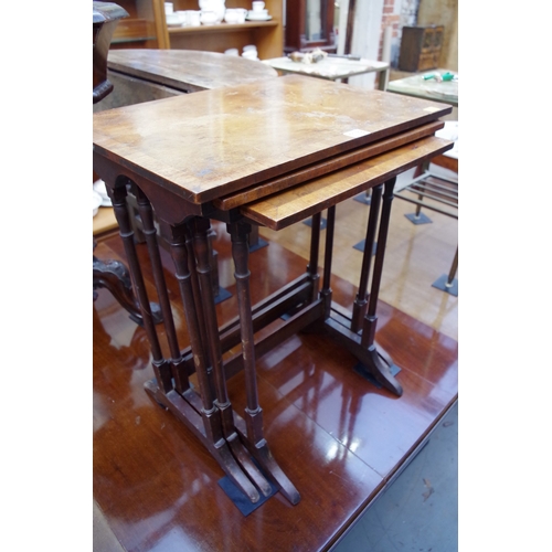 1179 - A nest of three walnut and crossbanded tables, largest 51cm wide. 