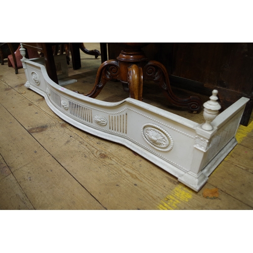 1335 - A neoclassical style white painted steel fender, 130cm wide.