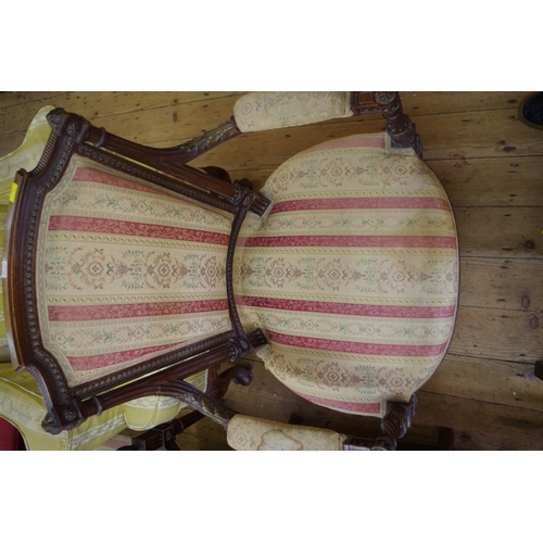 1367 - A pair of late 19th century carved mahogany and parcel gilt open arm elbow chairs. 