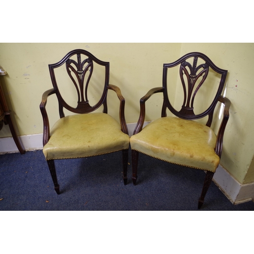 1373 - A pair of antique mahogany elbow chairs, with pale green leather seats. 