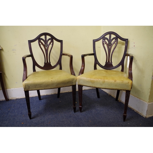 1373 - A pair of antique mahogany elbow chairs, with pale green leather seats. 