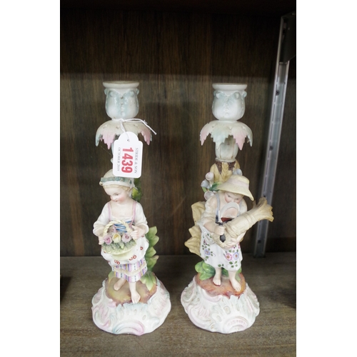 1439 - A pair of Sitzendorf porcelain figural candlesticks, emblematic of the seasons, 26.5cm high, (s... 