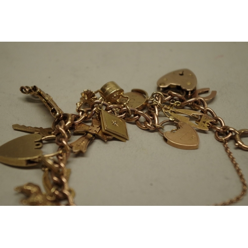 159 - A gold charm bracelet, stamped 375, having seventeen charms, some stamped 9ct, 38.2g gross weight.... 