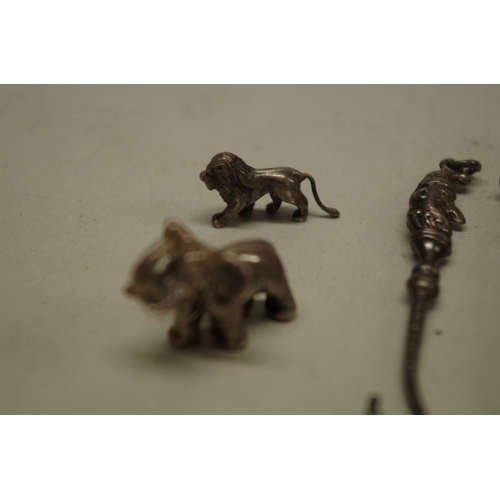 164 - A metal boar brooch; together with three charms; a silver bookmark and other items. (8)... 