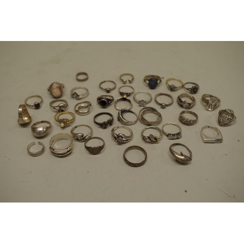 169 - A collection of silver and other metal rings.