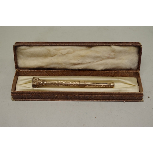 173 - A gold chased propelling pencil, having hardstone seal finial, stamped 9ct, 12.5cm extended, 16.3g g... 