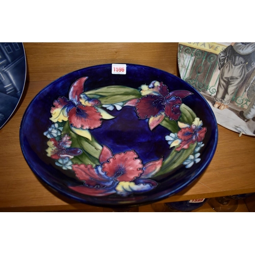 1596 - A large Moorcroft 'Slipper Orchid' pattern dish, paper label to base, 31.5cm diameter, tiny gla... 