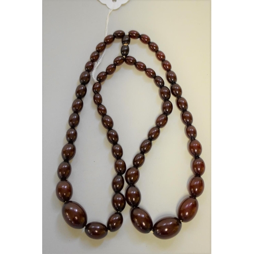 191 - A graduated cherry amber two strand bead necklace, 39.5cm, largest bead 25mm, weight 60.4g.... 