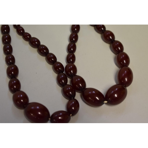 191 - A graduated cherry amber two strand bead necklace, 39.5cm, largest bead 25mm, weight 60.4g.... 