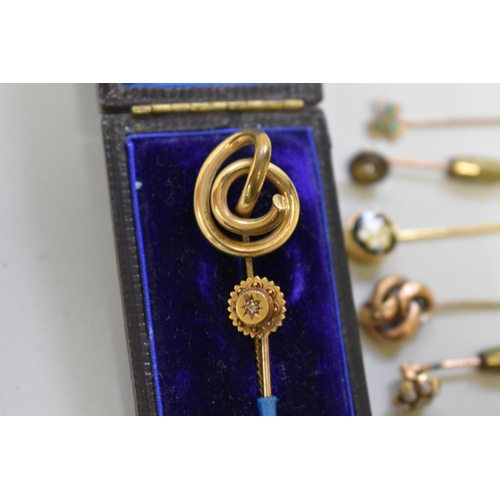 192 - A diamond set gold cravat pin, stamped 15ct; together with ten other unmarked examples.... 