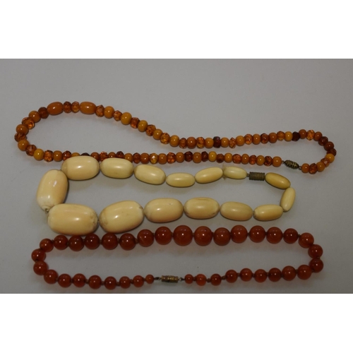 195 - A vintage carnelian bead necklace; together with two other beaded examples. (3)