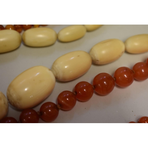 195 - A vintage carnelian bead necklace; together with two other beaded examples. (3)