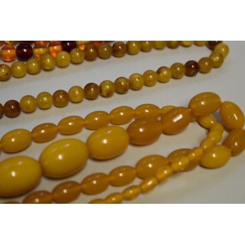 197 - Three strings of amber coloured beads.