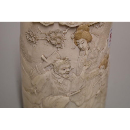 554 - A Japanese ivory tusk vase and cover, Meiji, carved in relief with a figure and geishas in a garden,... 