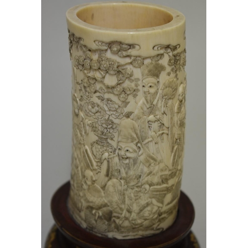 557 - A good Chinese ivory tusk vase, finely carved with a continuous band of figures, on gilt decorated w... 