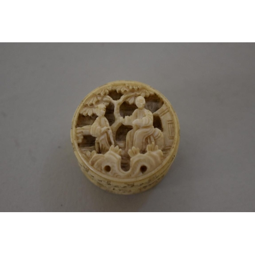 560 - A Chinese carved ivory concentric puzzle ball, 3.6cm diameter; together with another small carved iv... 