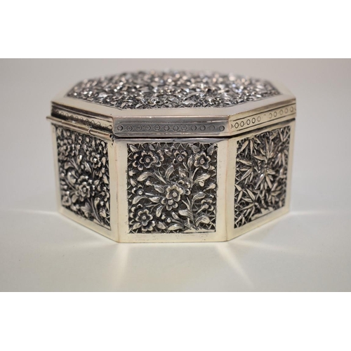 573 - A Chinese silver octagonal casket, marked to base, finely pierced and decorated with panels of flowe... 