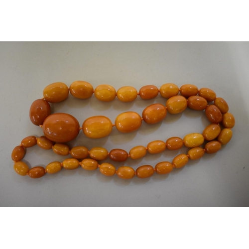 579 - A 'butterscotch' amber bead necklace, of forty three oval graduated beads, largest bead 4cm, 155g....