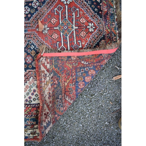 1108 - An Eastern rug, having three central medallions, with floral central field and geometric border... 