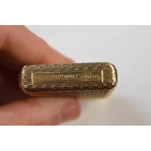 301 - A Calibri 9ct gold and gilt metal lighter, removable hallmarked cover 18g.