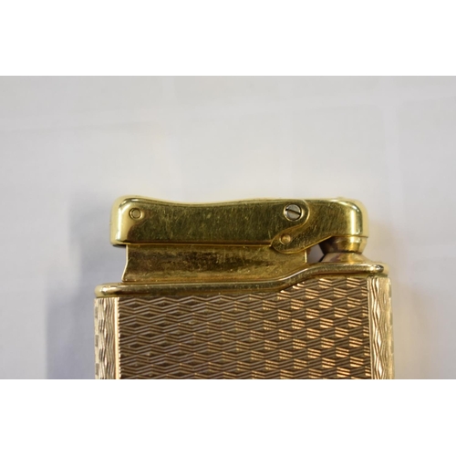 301 - A Calibri 9ct gold and gilt metal lighter, removable hallmarked cover 18g.