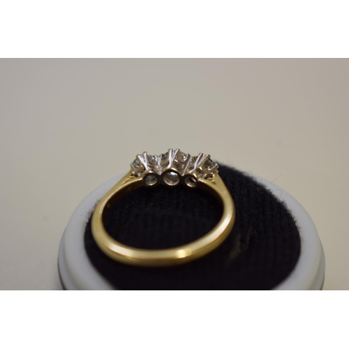 64 - A brilliant cut diamond three stone gold ring, hallmarked 750, 0.75ct approximately, 4.2g total weig... 