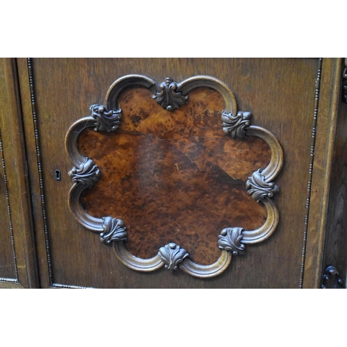 1178 - An early 20th century Continental oak and burr walnut side cabinet, 120cm wide. ... 