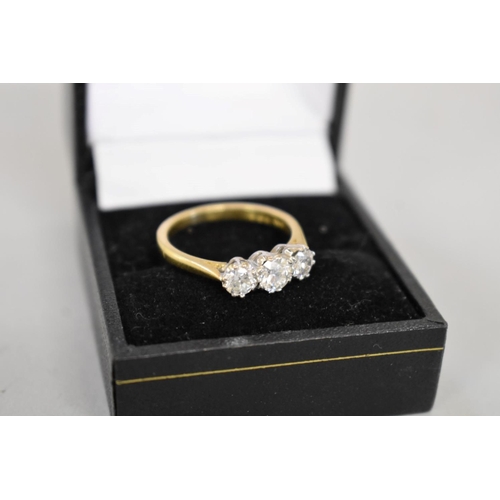 64 - A brilliant cut diamond three stone gold ring, hallmarked 750, 0.75ct approximately, 4.2g total weig... 