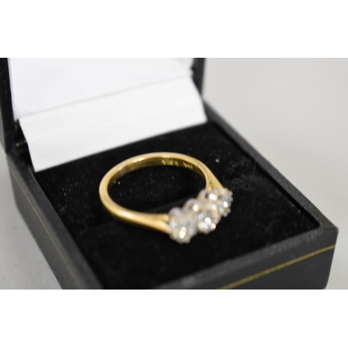 64 - A brilliant cut diamond three stone gold ring, hallmarked 750, 0.75ct approximately, 4.2g total weig... 